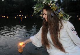 A girl puts a candle on the water