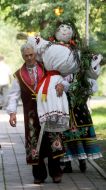 A man carries a scarecrow 