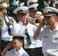A military orchestra performs the anthem