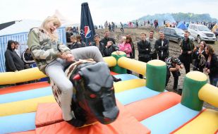 Young people ride Rodeo Bull attraction