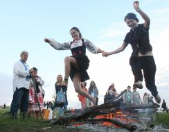 Girls jump over the fire