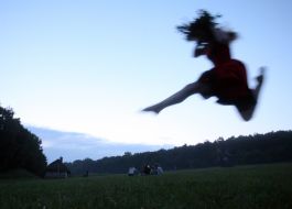 A girl wearing a crown jumps