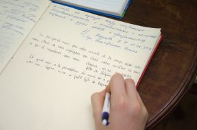 Writing in the Book of Honorary Guests