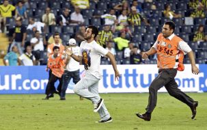 Steward of a stadium runs for a Turkish fan