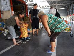 A seller is weighing a bag of pepper