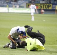 Steward of the stadium detain a fan