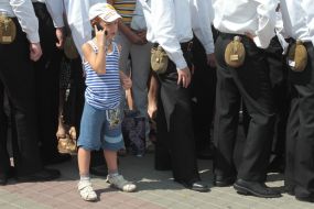 A boy speaks on a mobile telephone