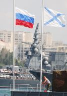 Sailor near the flags of Russia and Russia Navy