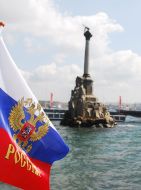 Flag of Russia near a monument to the flooded ships