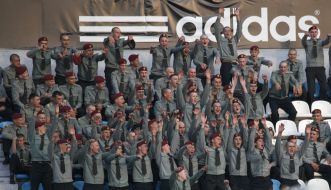 Servicemen cheer for their team