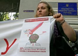 Participant of protest action against rising of price of condoms