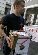 Participant of protest action against rising of price of condoms