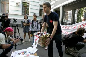 Participant of protest action against rising of price of condoms