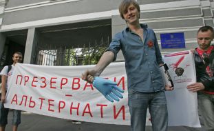 Participant of protest action against rising of price of condoms