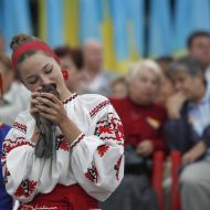 A girl kisses a pigeon
