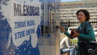 A girl puts money into the machine "Milk-bar"