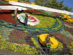 Workers assemble a floral clock