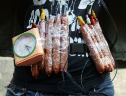 Girl shows self-made humor bomb made from sausages