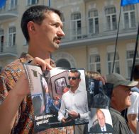 Участники акции держат фотографии политзаключенных