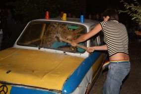 A girl smashes a car