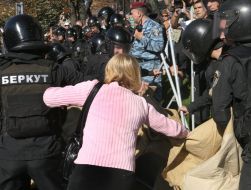Militia employees take away tents
