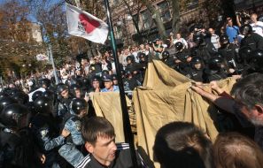 Militia employees take away tents
