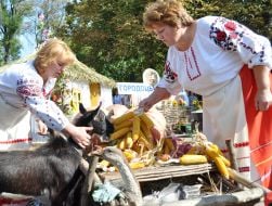 Women in the Ukrainian national suits near a goat