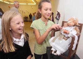 Girls examine a doll