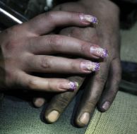 Hands of girl on the hand of miner