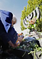 A woman lights a candle