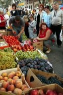 Visitors buy vegetables and fruit