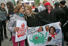 Participants of action holds a placards