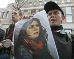 Participant of action hold a placard