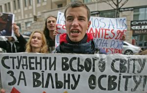 Participant of action hold a placard