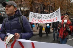 A young man beats by a spoon on a bowl