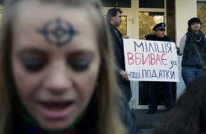 Participants of action hold placards
