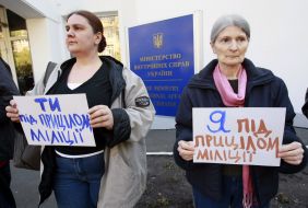 Participants of action hold placards
