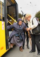 Elderly woman goes out from a trolleybus