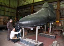 Yuriy Aleksandrov near 5-meter soccer boots