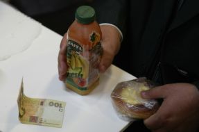 The participant of convention buys cheese-cake and juice 