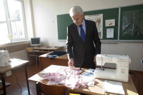 Elderly woman gives flowers to Vladimir Litvin