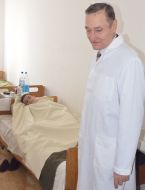 Doctor near beds of sick boy