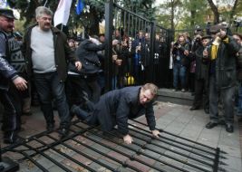 Protest action participants demolish fence