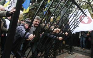 Protest action participants demolish fence