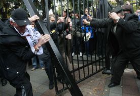 Protest action participants demolish fence
