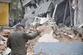 A man stand near the destroyed building morgue