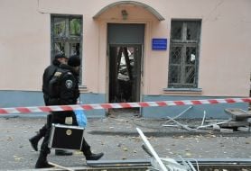 Police officers goes near the destroyed building morgue