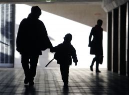 A mother and child are going through an underpass