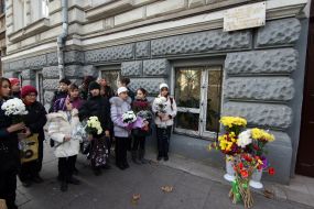 Ceremony of laying-on of flowers near at building, where Peter Stolyarskiy lived