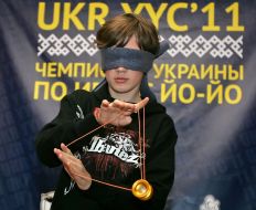 A boy plays with a yo-yo